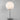 Witte tafellamp met bolvormige kap, metalen voet, modern design, interieurverlichting.
