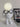 Witte hars robot tafellamp met bril naast laptop, modern design, sfeerverlichting.