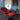 Rode fauteuil met voetenbank, moderne woonkamer, boekenplank, abstract schilderij, design interieur.