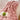 Roze pluchen deken op stoel met open boek en groene appel, gezellige interieurdecoratie.