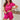 Vrouw in roze satijnen pyjama set, korte mouwen, comfortabele nachtkleding.