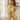 Vrouw in gouden satijnen pyjama set met hartdetail, comfortabele nachtkleding.