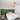 Groene slaapkamer met tweepersoonsbed, witte dekbedovertrek, houten nachtkastjes, moderne verlichting.