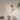 Zwarte hanglamp met twee kappen, modern design, boven beige bank, minimalistisch interieur.