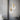 Twee moderne hanglampen met gouden accenten en ronde LED-verlichting in een minimalistisch interieur.