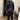Man in zwarte satijnen pyjama, slaapkamer, luxe nachtkleding, comfortabele slaapkleding.