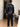 Man in zwarte satijnen pyjama, slaapkamer, luxe nachtkleding, comfortabele slaapkleding.